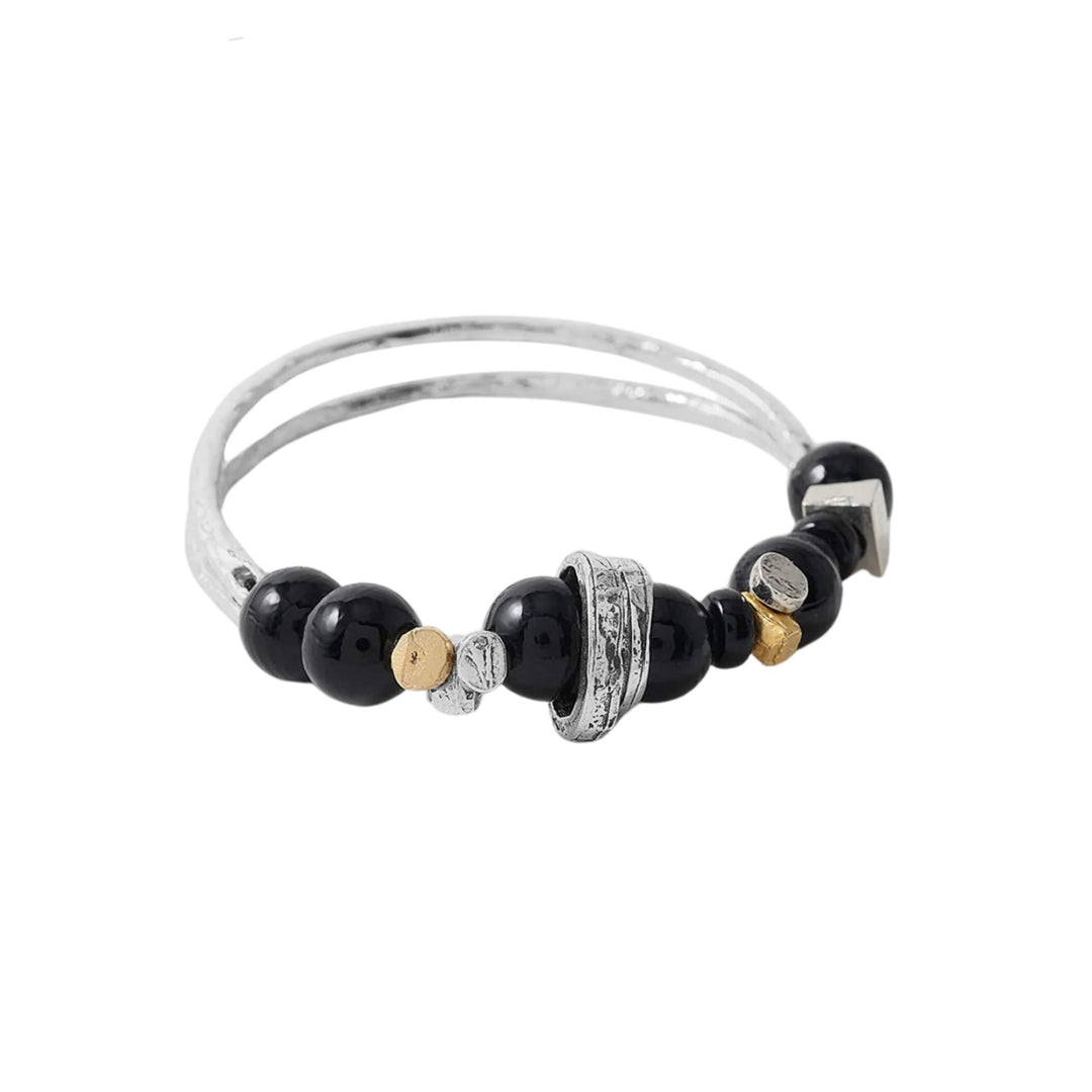 Bracelet Idriss avec billes noires et ornements argentés et dorés par Anne-Marie Chagnon