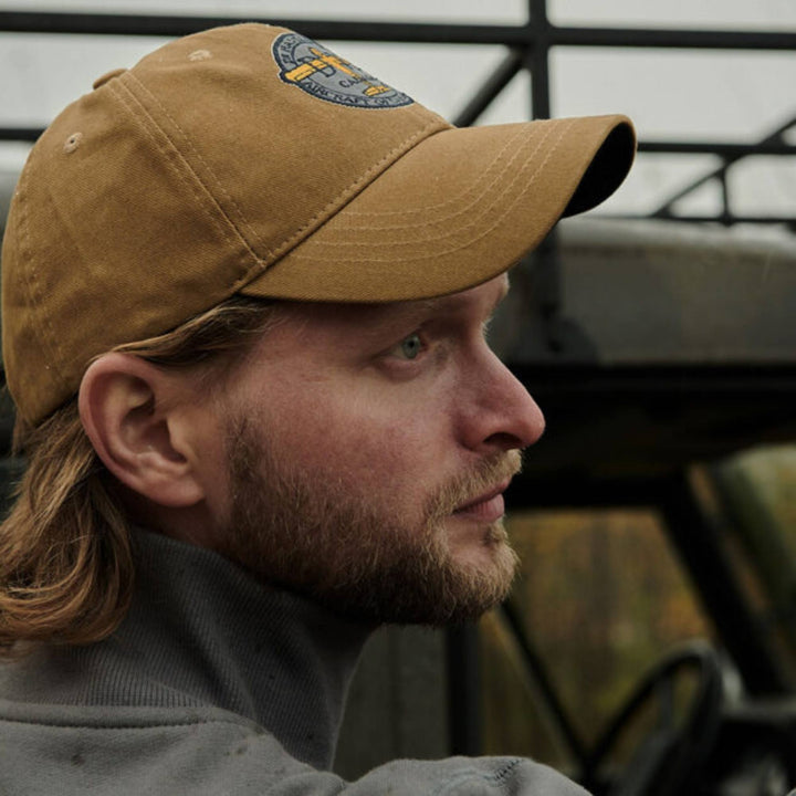 Homme portant une Casquette tan De Havilland avec logo par Red Canoe vu de côté