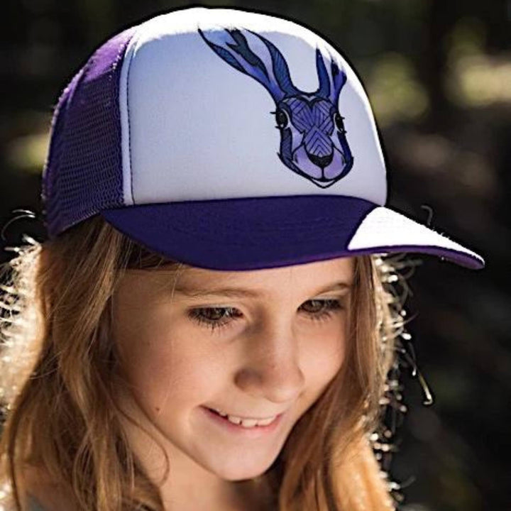 Jeune fille portant une Casquette blanche, mauve et noire avec un motif de lièvre sur le devant