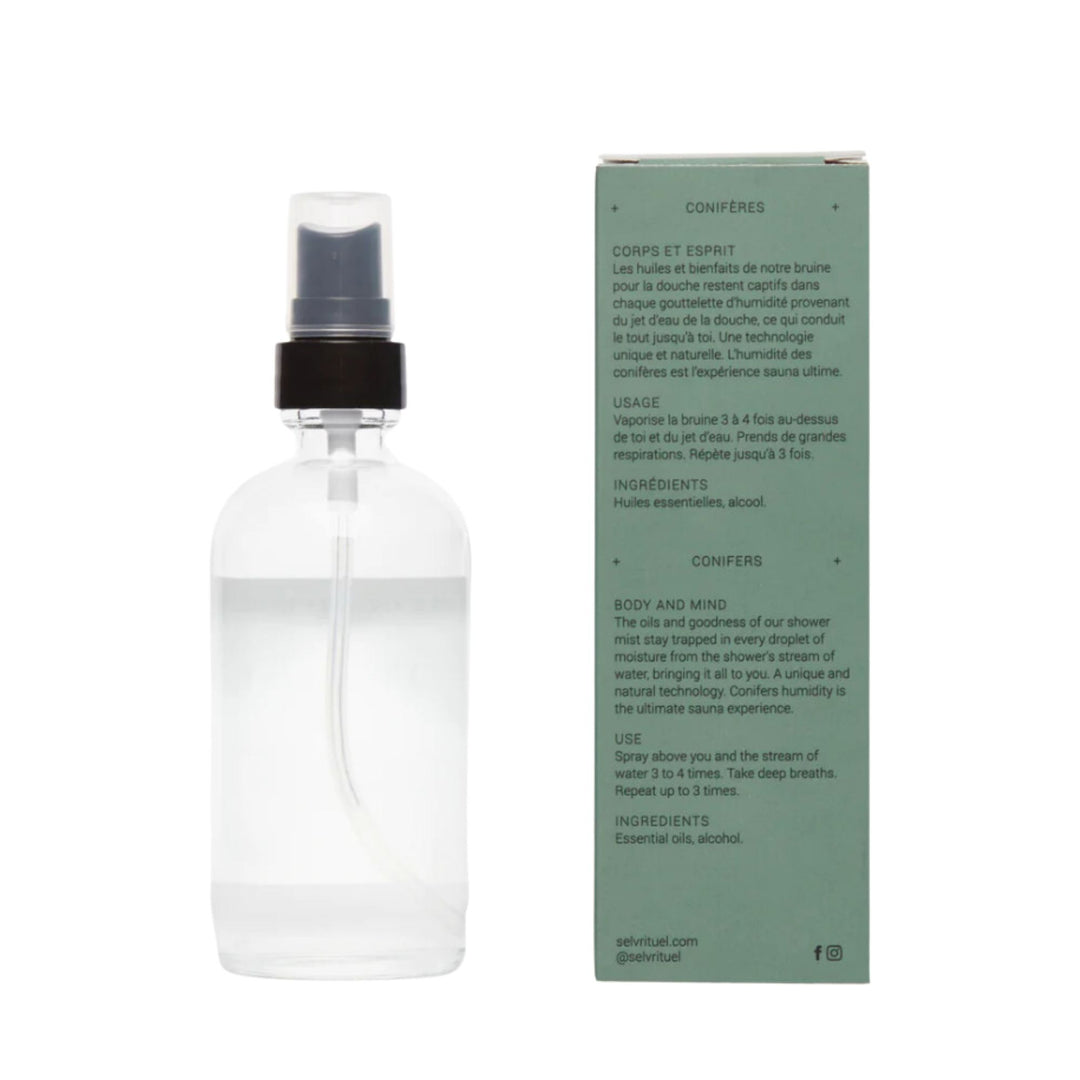Bouteille de bruine boreale vue de derriere à côté de sa boîte verte