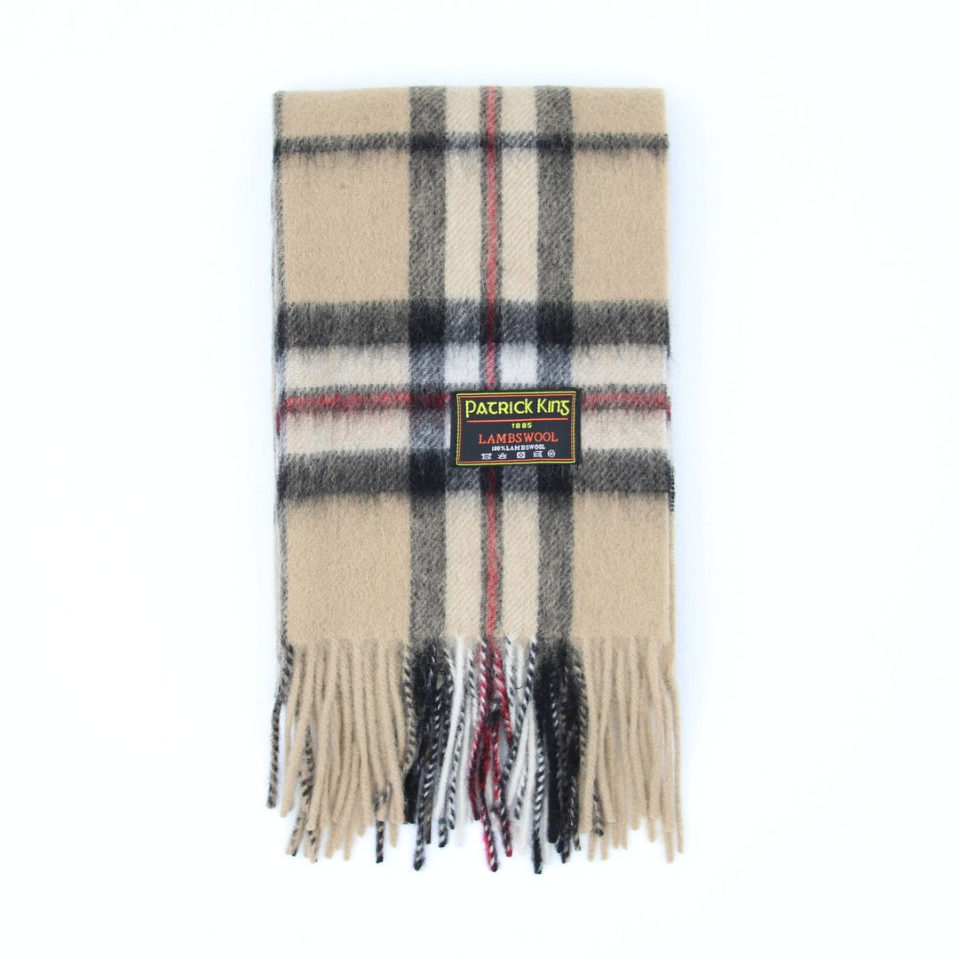 Foulard en laine d'agneau tartan beige avec lignes charcoal et une franche plié avec une étiquette d'identification Patrick King attachée au foulard