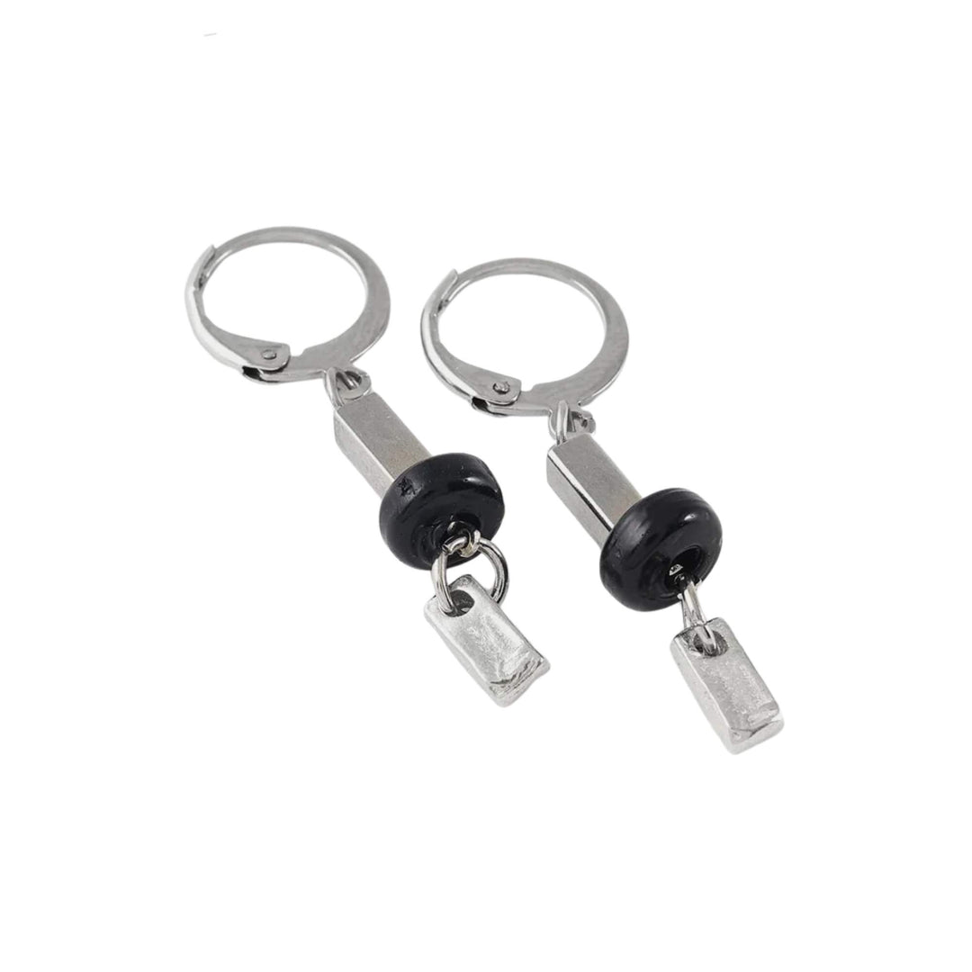 Boucles d'oreilles avec lamelles argentées munies d'une bille noire par Anne-Marie Chagnon vues de près