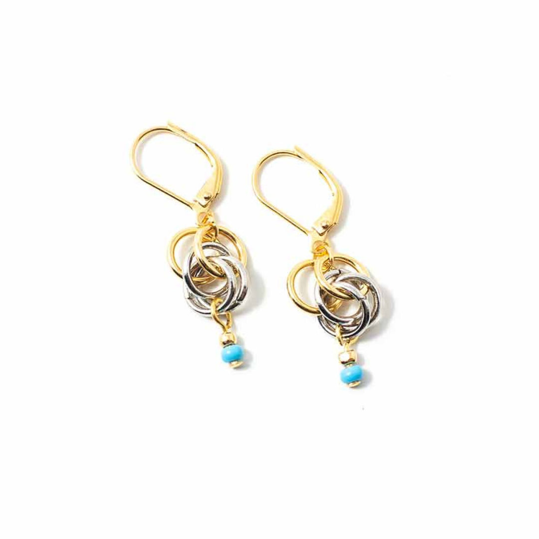 Boucles d'oreilles Anne-Marie Chagnon Bime dorées et argentées avec forme circulaires et pierre turquoise au bout